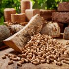 High,Angle,Of,Wood,Cylindrical,Pellets,Scattered,On,Timber,Table